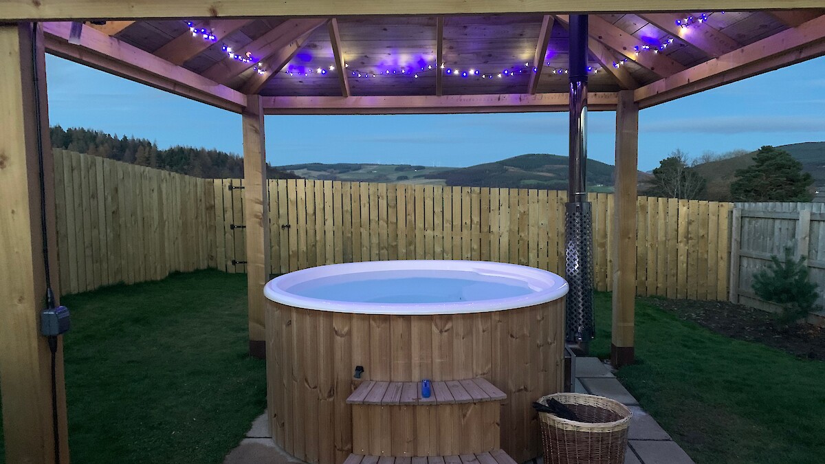 Large hot tub with gazebo with lights